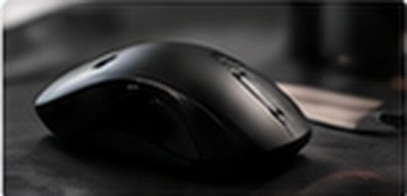 Black gaming mouse on a dark desk
